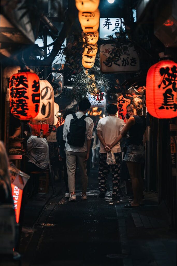 pexels-photo-17930234 Urban street with illuminated lanterns in Tokyo's Yanaka Alley at night, capturing local culture.